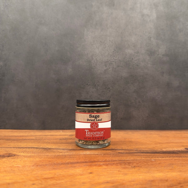 Jar of Sage Dried Leaf on a wooden surface with a gray background
