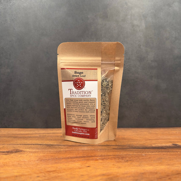 Packaged sage from Tradition Spice Company on a wooden surface with a gray background