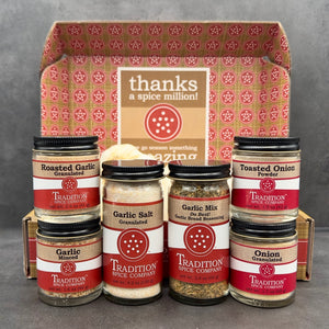 Collection of spice jars from Tradition Spice Company with a decorative box in the background.