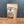 A stand-up pouch of Tradition Spice Company Onion Minced spice mix, displayed on a wooden surface against a dark gray background.