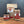 Three jars and one large bag of onion mince spice from Tradition Spice Company arranged on a wooden surface against a dark gray background.