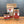 Three containers of Ground Saigon Cinnamon from Tradition Spice Company sit on a wooden surface, including a small jar, a larger jar, and a brown resealable pouch with red and white labels on each—perfect for those seeking premium cinnamon baking spices.