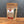 A stand-up pouch of Tradition Spice Company Dill Weed Dried Flakes standing on a wooden surface against a dark gray background.