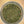 A top-down view of loose green tea leaves inside a clear glass jar, set against a warm yellow-beige background.