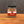 A jar of Tradition Spice Company Celery Salt Granulated, sitting on a wooden surface against a dark gray textured background.