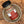 A jar of Tradition Spice Company Celery Salt Granulated, resting inside a rustic metal bowl.