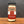A glass jar of Tradition Spice Company Horseradish Powder with a black metal lid, set on a wooden surface against a dark gray background.