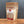 A stand-up pouch of Tradition Spice Company Horseradish Powder, filled with pale beige powder, set on a wooden surface against a dark gray background.