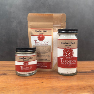 Three containers of Coarse Kosher Salt—small glass jar, paper pouch, and large glass jar—are shown on a wooden surface, each with red and white labels. Ideal as cooking salt for your favorite recipes.