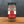 A glass jar of Dream Dill, Da Best! Dill Dip & Dressing Mix rests on a wooden surface, displaying a red and beige label with a circular logo and descriptive text about the blend.