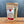 A brown resealable pouch labeled Dream Dill, Da Best! Dill Dip & Dressing Mix rests on a wooden surface. The label features product details and a clear window that reveals the flavorful herbs inside.
