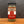 A glass jar of Tradition Spice Company Dreamy Dill Dill Dip & Dressing Mix with a black lid, set on a wooden surface against a dark gray background.