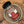 A glass jar of Tradition Spice Company Taste of Tuscany Bread Dip Mix with a black lid, resting inside a ceramic bowl on a wood background.