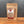 A stand-up pouch of Tradition Spice Company Honey Aleppo Pepper dry rub seasoning, displayed on a wooden surface against a dark gray background.