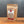 A stand-up kraft paper pouch of Tradition Spice Company Honey Habanero Dry Rub Seasoning, standing on a wooden surface against a dark gray background.