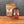 A glass jar and a stand-up pouch of Tradition Spice Company St. Louis Ribs Dry Rub Seasoning, displayed side-by-side on a wooden surface against a dark gray background.