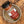 A glass jar of Tradition Spice Company St. Louis Ribs Dry Rub Seasoning with a black lid, resting on a rustic ceramic dish over a wood-grain surface.