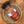 A glass jar of Tradition Spice Company Memphis Style Dry Rub Seasoning with a black lid, resting on a rustic ceramic dish over a wood grain surface.