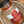 A close-up of a glass jar of Kansas City BBQ Dry Rub Seasoning by Tradition Spice Company, showing the spice rub inside and the label details, resting in a metal bowl.