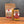 A stand-up pouch and a glass jar of Tradition Spice Company Carolina Gold BBQ Dry Rub Seasoning displayed on a wooden surface against a dark gray background.