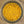 A top-down view of a clear glass jar filled with a coarse yellow-orange powder, set on a speckled beige countertop.