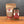 A glass jar and a stand-up pouch of Tradition Cowboy BBQ Dry Rub Seasoning from Tradition Spice Company, displayed on a wooden surface against a dark gray background.