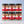 Six glass jars of Tradition Spice Company ground spices arranged in two rows of three on a light marble surface against a pale blue-gray background. The jars include Allspice, Cinnamon, Ginger, Cardamom, Cloves, and Nutmeg, each with a black lid and a red-and-beige label.