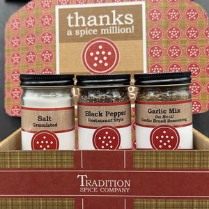 The Welcome Home Gift Box features three spice jars—Salt, Black Pepper, and Garlic Mix—displayed in a Tradition Spice Company box. Perfect for housewarmings, it comes with a sign that says “thanks a spice million!”.