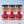 Three glass jars of Tradition Spice Company seasoning blends lined up on a light marble surface against a pale blue background. The jars are labeled Lemony Pepper, Sublime Lime, and Zesty Chicken.