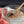 Glass bowl with spices and a spoon next to raw meat