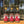 The American Kitchen Mega Pack from Tradition Spice Company features three citrus spice blends—Zesty Chicken, Lemony Pepper, and Sublime Lime—displayed outdoors on wood with gold trophies, perfect for any weeknight meal. Pine trees blur behind.